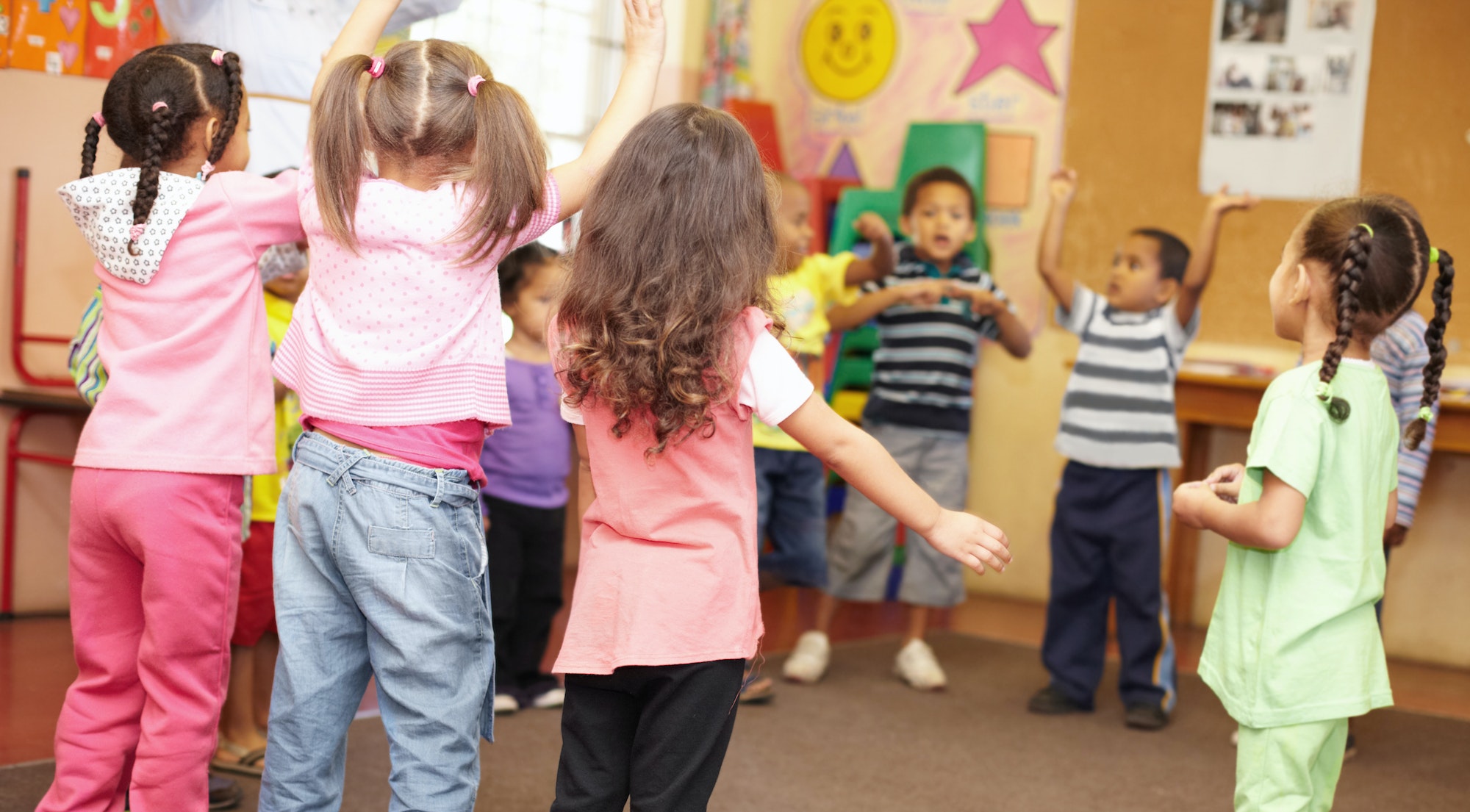 Dancing to get rid of all the energy. Preschool students jumping and dancing around having fun.